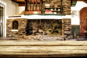 Desk of free space and fireplace in home interior. Wild west background. 