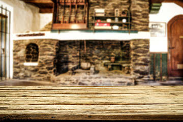 Desk of free space and fireplace in home interior. Wild west background. 
