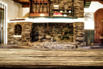 Desk of free space and fireplace in home interior. Wild west background. 