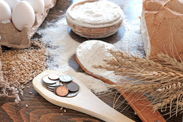 Wheat ears and grains , bread , eggs on the table. Sifted flour. Components for baking fresh bread....