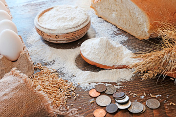Wheat ears and grains , bread , eggs on the table. Sifted flour. Components for baking fresh bread....