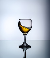 stream of wine being pouring into a glass closeup