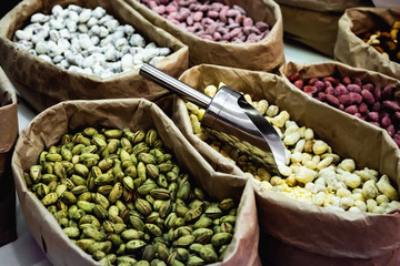 Raw nuts in paper bags at a market place. Peanuts, cashews and almonds.
