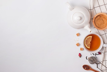 Cup, teapot and sugar on the white background, top view