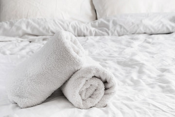 Fototapeta na wymiar Clean white towels on the white bed