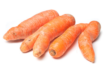 closeup of deformed carrots on white background