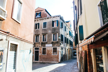 Fototapeta na wymiar Traditional view of a street in Venice, Italy. Panorama of Venice on a sunny summer day.