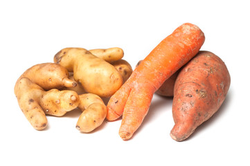 closeup of deformed vegetables on white background