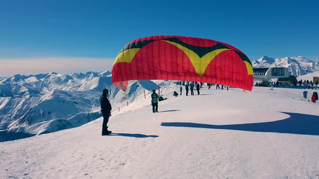 Snowy paragliding in mountains