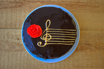 Top View Of A Chocolate Cake With A Stylized Image Of A Musical Staff (Stave) With A G-Clef And A...