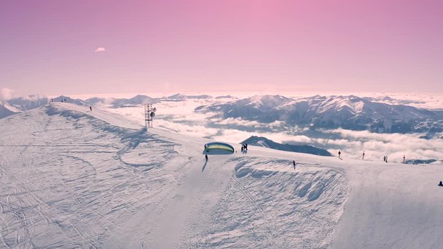 Snowy paragliding in mountains