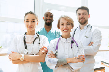 Fototapeta premium Healthcare people group. Professional male and female doctors posing at hospital office or clinic. Medical technology research institute and doctor staff service concept. Happy smiling models.