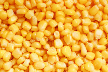 Golden canned corn, as distributed on a plane background and texture of popcorn. Before watching a movie top view. Close-up