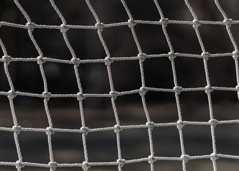 Football net close up. Interlacing white ropes. Old soccer gate.