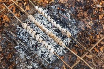 Cooking dough on skewers on a fire