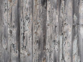 Texture of wood and old paint. Gray wooden wall with cracked paint. 