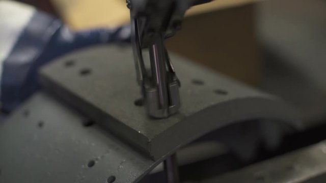 A Rivet Machine Punches into a Break Pad