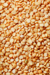 Background texture of pea porridge golden color in full-frame form. View from above. Close-up