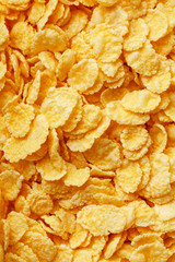Golden cornflakes background and texture. View from above. cornflakes healthy breakfast. Close-up. macro