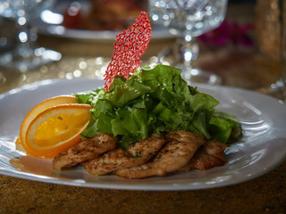 Meat roasted on fire with lemon and green salad.