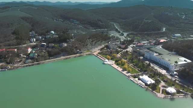 Winery and embankment of Abrau-Durso in summer. The village on the shore Calm, blue sky. Filming with drone. Beautiful futage