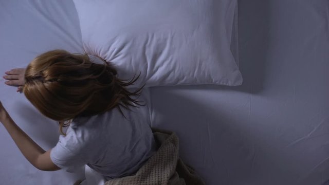 Woman taking painkillers or sedatives before sleeping, psychical disorder