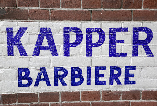 wall with barber shop text in Dutch and Italian