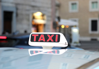 TAXI text above the car for transporting people into the city