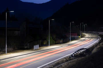 modern streetlights with LED technology at night, car light paths