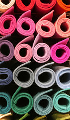 big rolls of fabric in the shelf of the tailoring