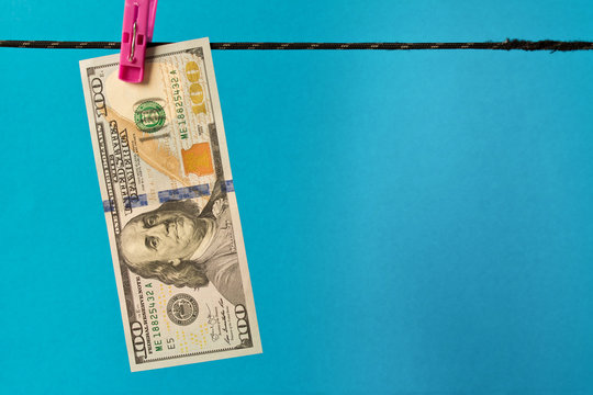 100 dollar bill on the clothesline. The concept of money laundering.
