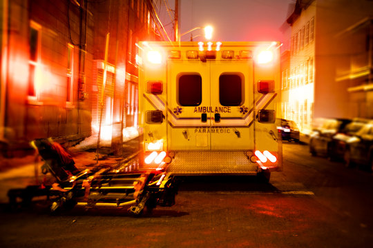 An Ambulance Car Parked On The Side Street At Night