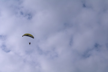 paraglider in the sky,sky, paragliding, parachute, freedom, adventure, clouds, cloud, glider, high, flight, wind, activity, fun,  