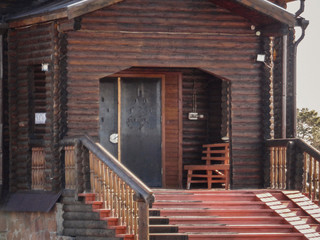 Christian wooden temple closeup. Entrance to the Christian church. Orthodox. Log building. Wooden building background. Ust-Kamenogorsk (Kazakhstan)