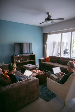 Couple using technolgy at home