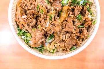 Gyudon or strip beefs with a lots of onion leeks and topped with fresh egg yolk