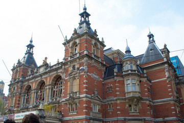 Authentic Amsterdam streets. Architecture, transport and bustle of the townspeople and tourists on the streets. Netherlands