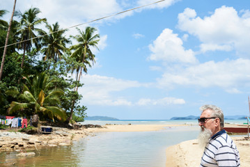 Bearded man on the beach in tropical island in summer.