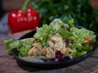 Portion of meat sprinkled with white sauce.
