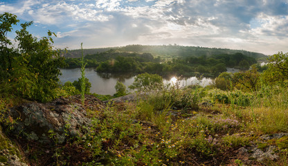 Panorama with bank of river in morning fog