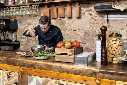 Man making salad mix with dressing