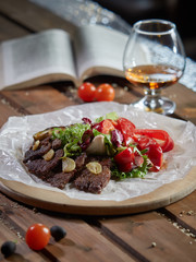 Slices of roast beef with garlic and red pepper.