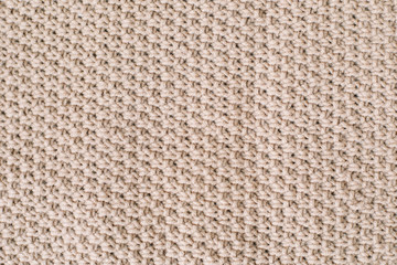 Knitted background. Knitting pattern of wool. Knitting. Texture of knitted woolen  fabric for wallpaper and an abstract background