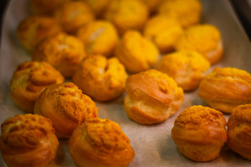 Delicious eclairs. Bakery in the oven. Confectionery. Yellow small ecriles