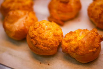 Delicious eclairs. Bakery in the oven. Confectionery. Yellow small ecriles