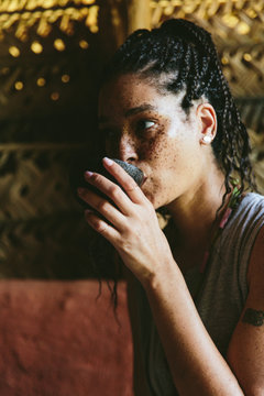 Woman Drinking Tea In An Exotic Hut