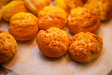 Delicious eclairs. Bakery in the oven. Confectionery. Yellow small ecriles