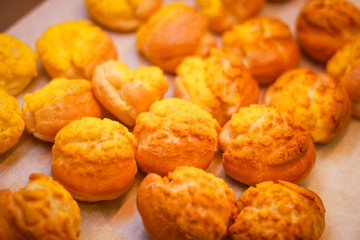 Delicious eclairs. Bakery in the oven. Confectionery. Yellow small ecriles