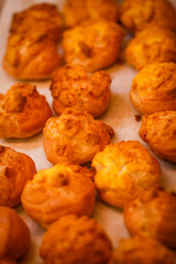 Delicious eclairs. Bakery in the oven. Confectionery. Yellow small ecriles