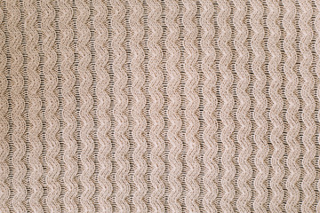 Knitted background. Knitting pattern of wool. Knitting. Texture of knitted woolen  fabric for wallpaper and an abstract background